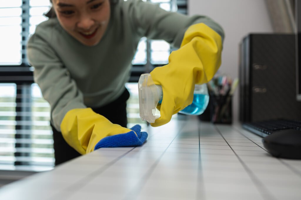 a company's cleaning lady is diligently cleaning the executive's office, the cleaning lady wears rubber gloves to prevent irritation form chemicals while cleaning
